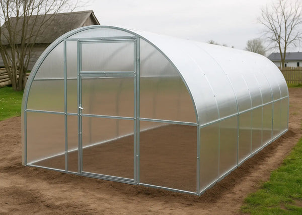 Polycarbonat greenhouse Titan plus  width 3,5m on a grass patch with trees and houses in the background