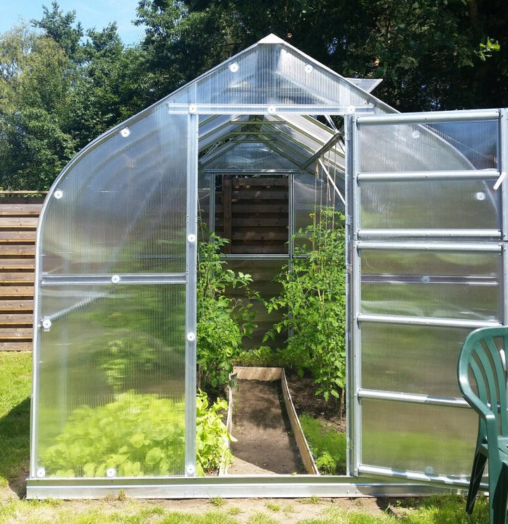 Greenhouse with open door in a garden setting
